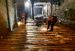 To house powerful new tunnel ventilation fans, a “second floor” was built over the tracks. Two massive steel bridges were built across both tunnels. Here, the steel decking is being welded in place to support a concrete floor.